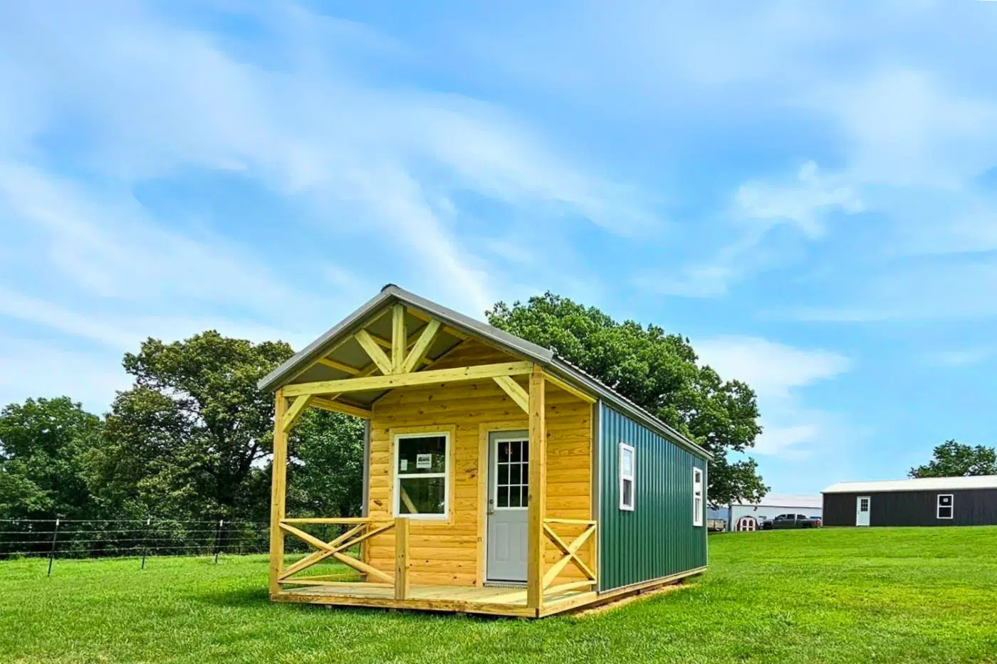 Cozy Cove prebuilt cabin with log siding and covered porch