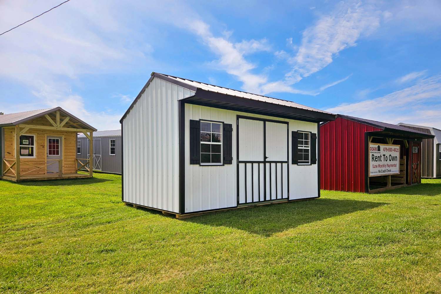 Metal white and black shed with double doors and two windows